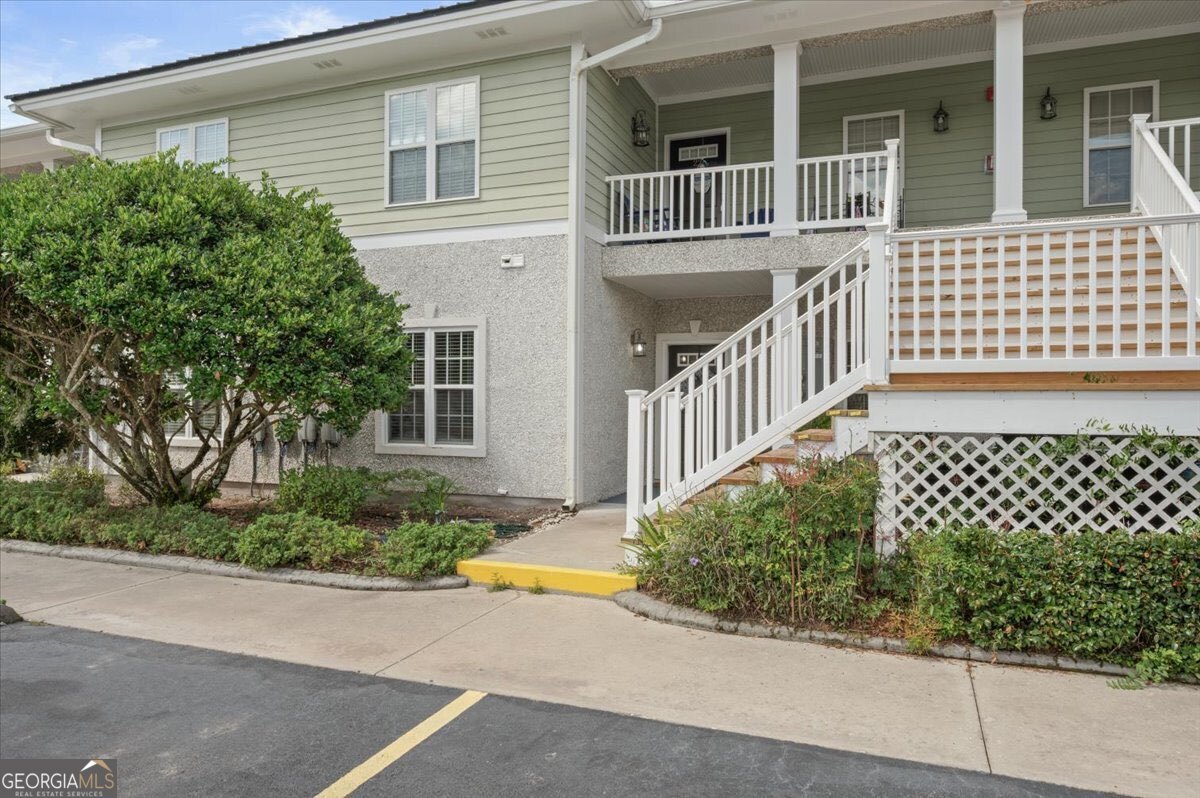 7272 Shellman Bluff Road Northeast, Unit 21 Townsend, GA 31331 - Photo 31 of 34 a view of a house with a small yard and wooden fence