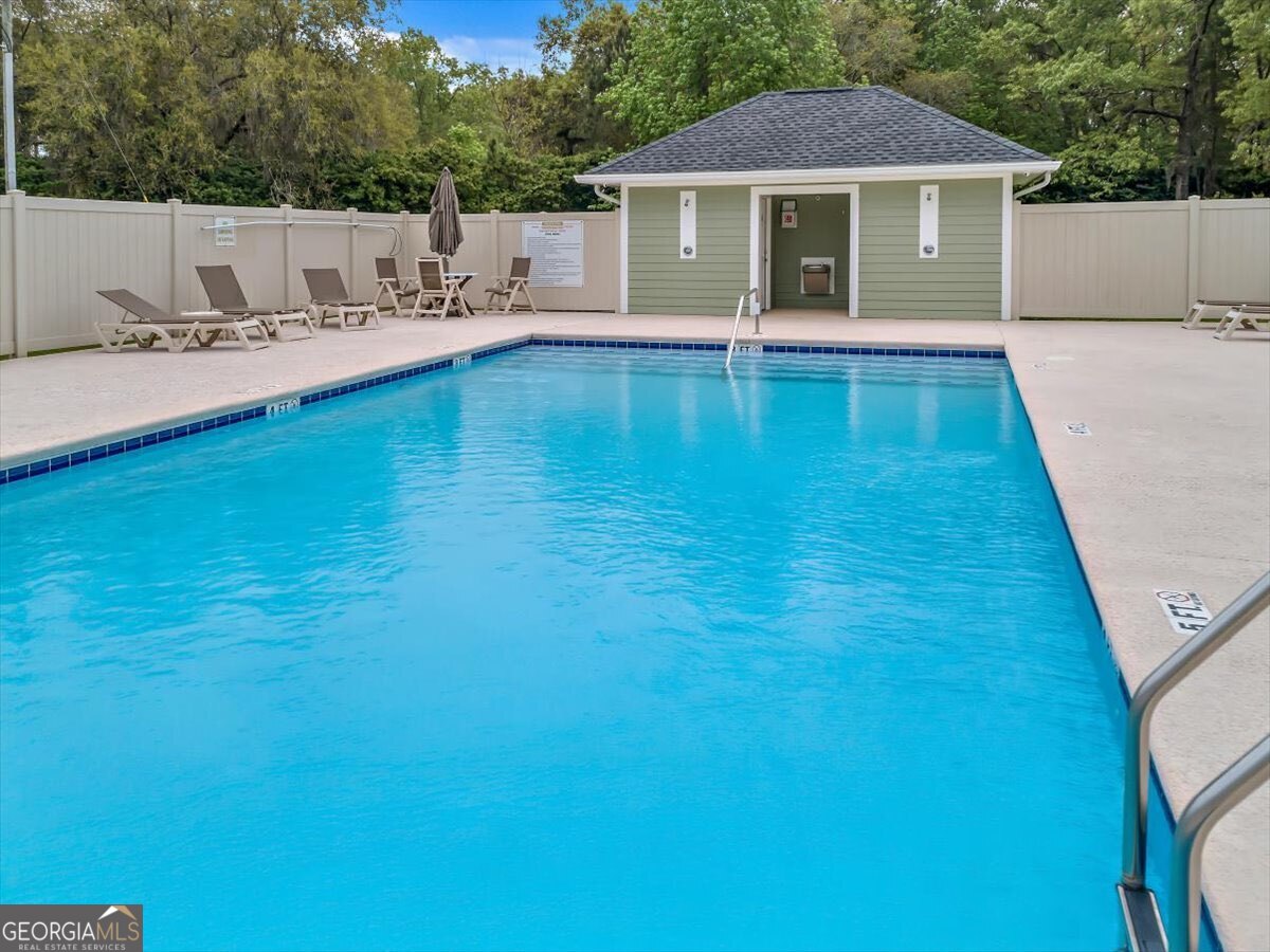 7272 Shellman Bluff Road Northeast, Unit 21 Townsend, GA 31331 - Photo 34 of 34 a view of a house with pool and a yard