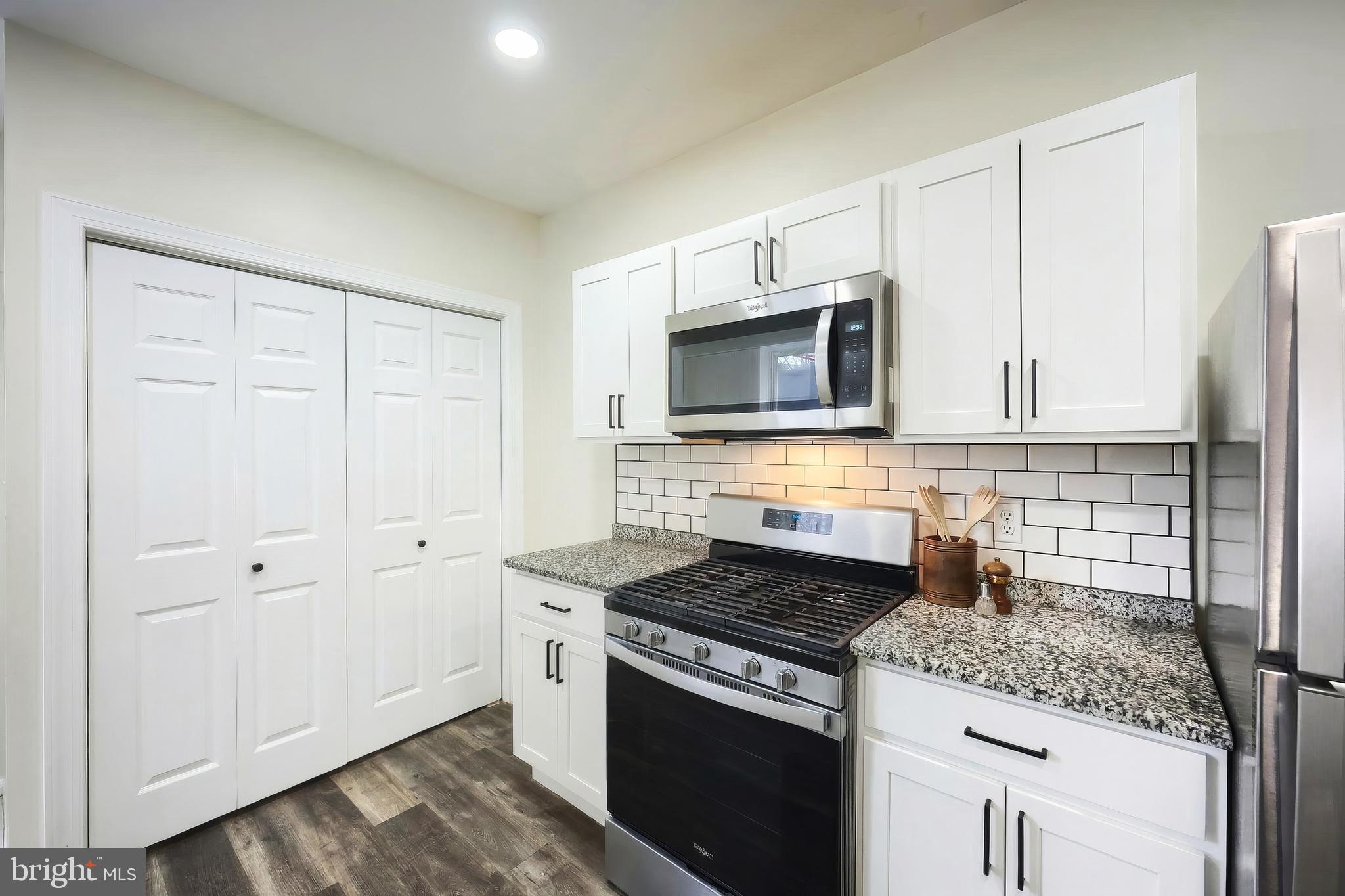442 East Prospect Street York, PA 17403 - Photo 14 of 33 a kitchen with granite countertop a sink stove and microwave