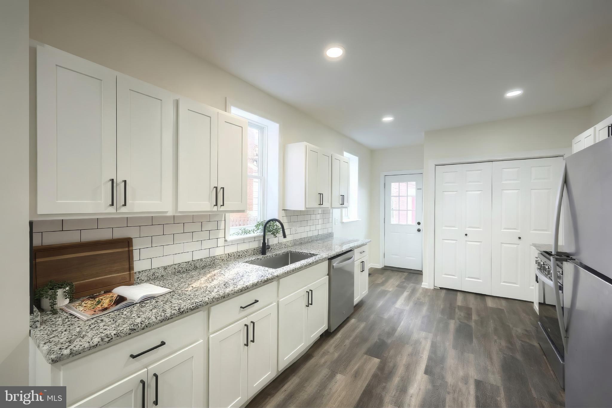 442 East Prospect Street York, PA 17403 - Photo 10 of 33 a kitchen with granite countertop white cabinets and sink
