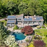 an aerial view of a house with yard swimming pool and outdoor seating