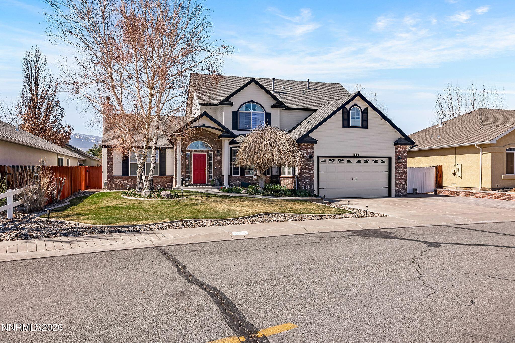 1666 Dogleg Road Carson City, NV 89701 - Photo 1 of 24 a front view of a house with a yard