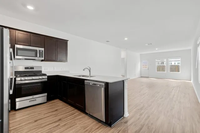 a kitchen with stainless steel appliances granite countertop a stove and a sink