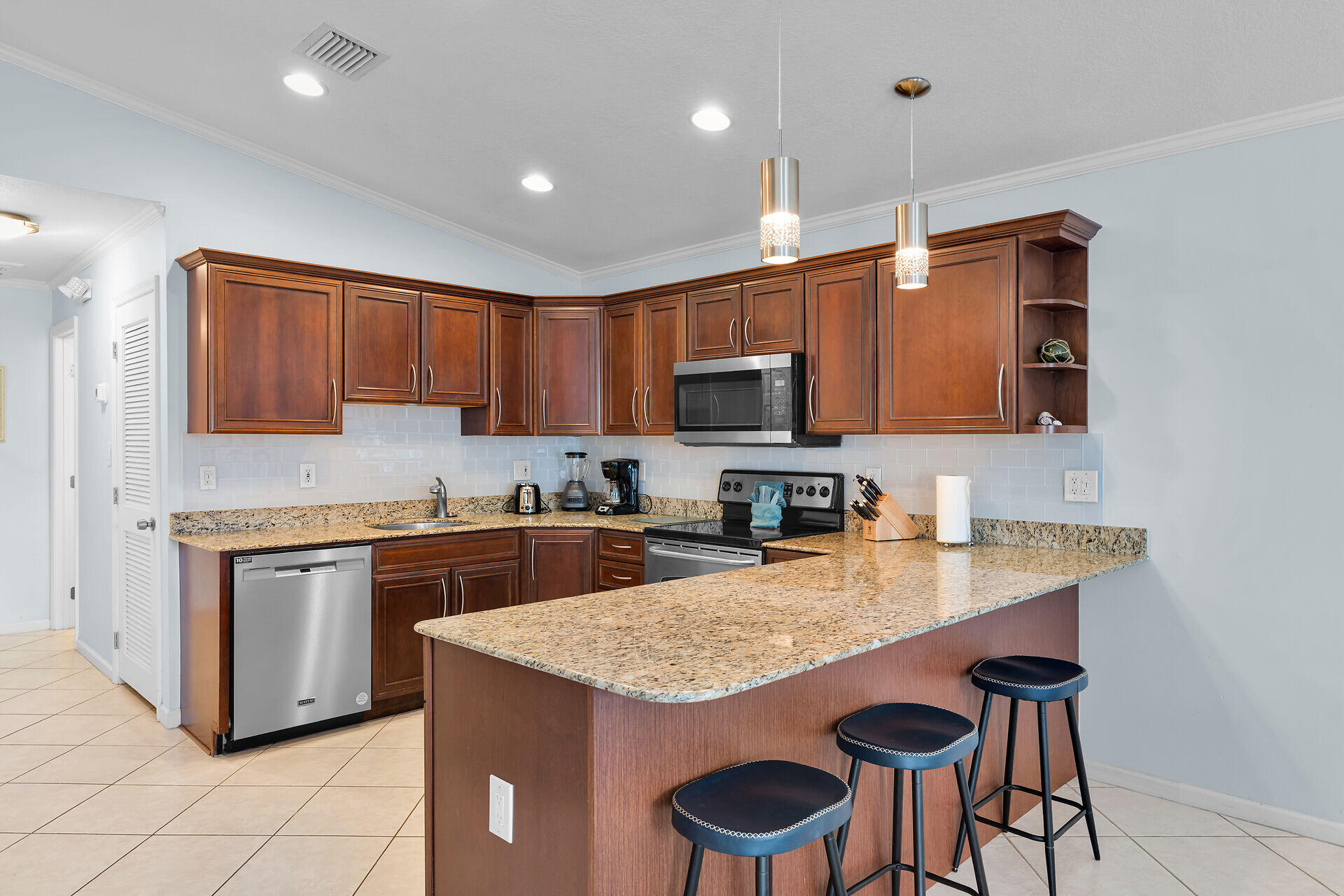 270 Sadowski Key Key Colony Beach, FL 33051 - Photo 8 of 46 a kitchen with stainless steel appliances granite countertop a stove a sink and a microwave