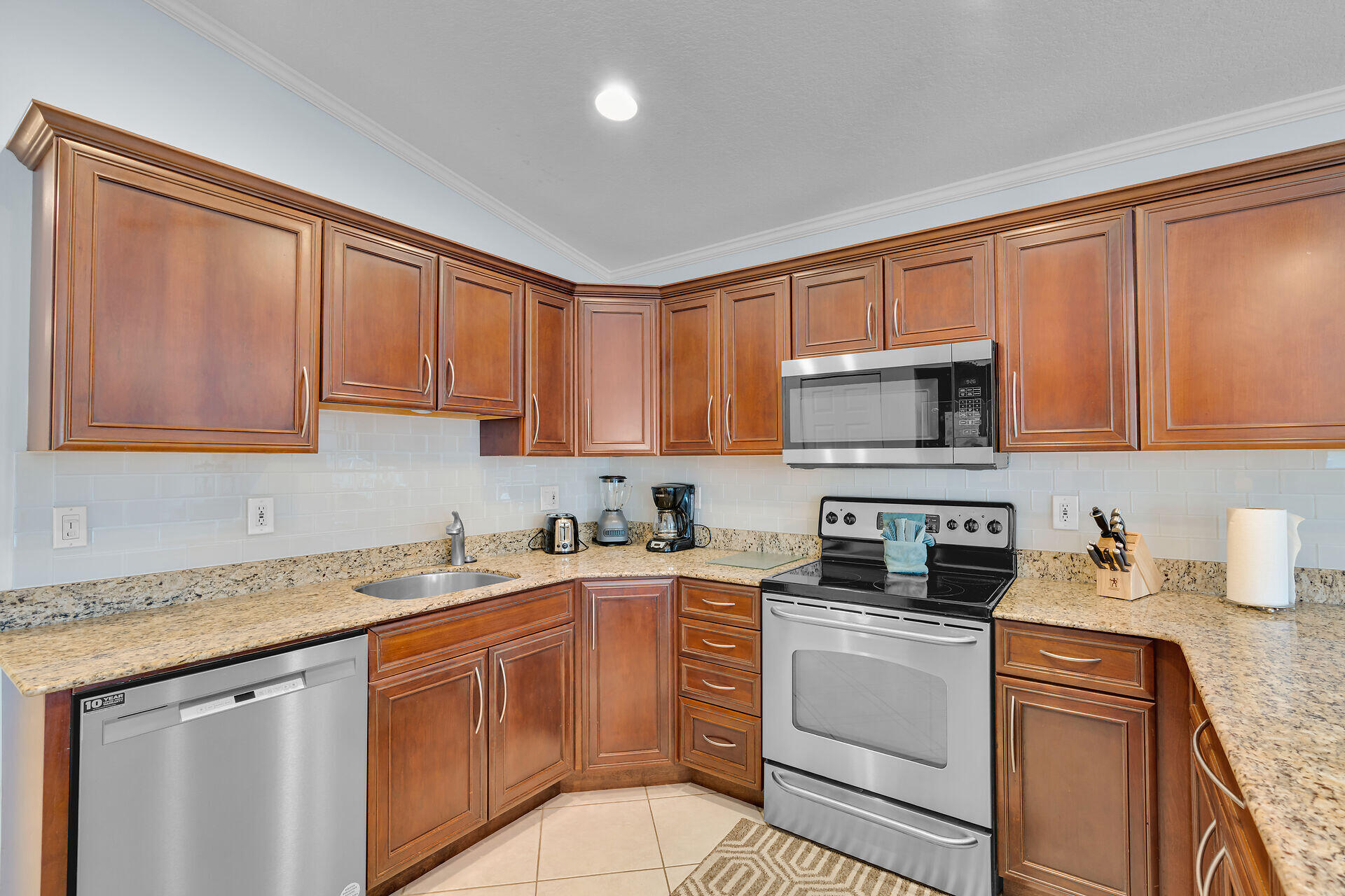 270 Sadowski Key Key Colony Beach, FL 33051 - Photo 12 of 46 a kitchen with stainless steel appliances granite countertop a sink stove and microwave with cabinets