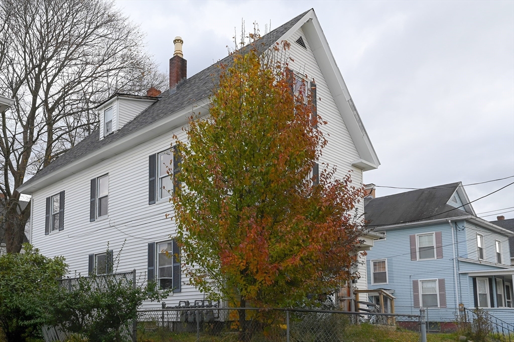 80-82 Maple Street Gardner, MA 01440 - Photo 3 of 4 front view of a house with a large tree