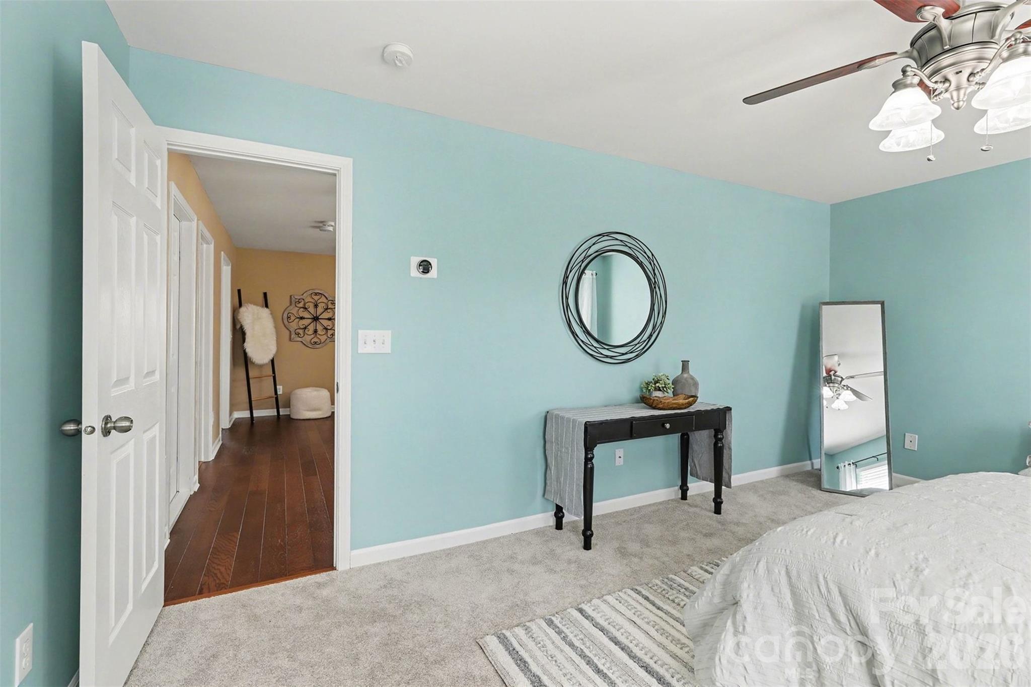 1806 Tradd Avenue Clover, SC 29710 - Photo 16 of 30 a bedroom with a bed and a chandelier
