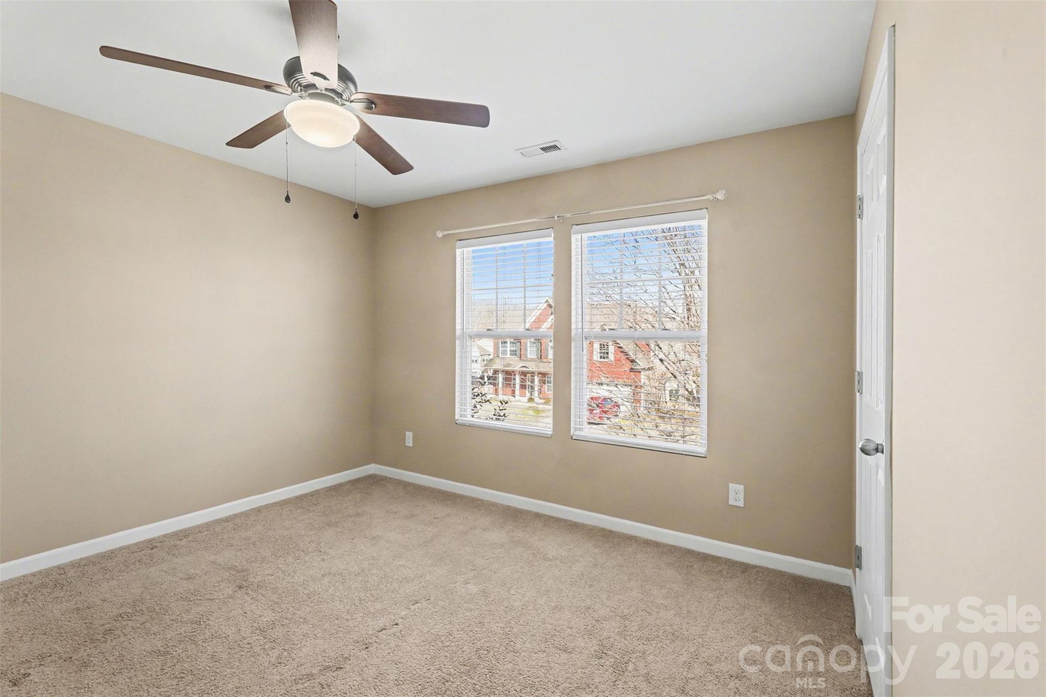 1806 Tradd Avenue Clover, SC 29710 - Photo 19 of 30 an empty room with a window and ceiling fan