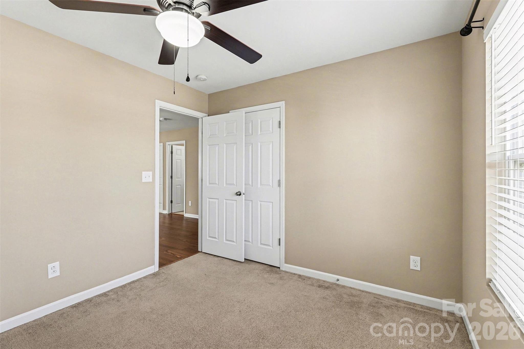1806 Tradd Avenue Clover, SC 29710 - Photo 22 of 30 an empty room with a window and a fan