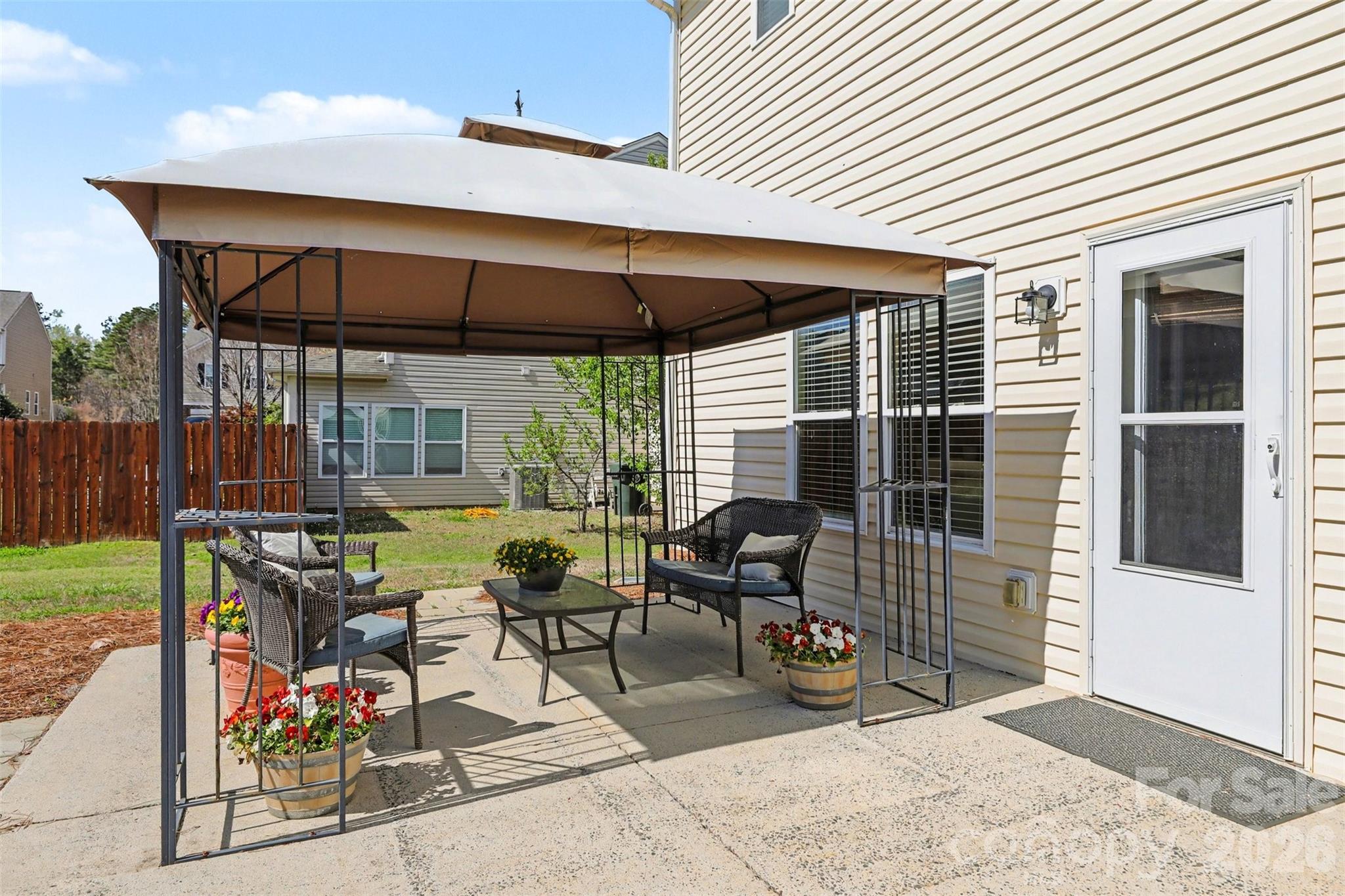 1806 Tradd Avenue Clover, SC 29710 - Photo 24 of 30 a view of a patio with table and chairs and floor to ceiling window