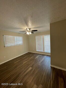 4315 41st Street Lubbock, TX 79413 - Photo 10 of 14 an empty room with wooden floor fan and windows