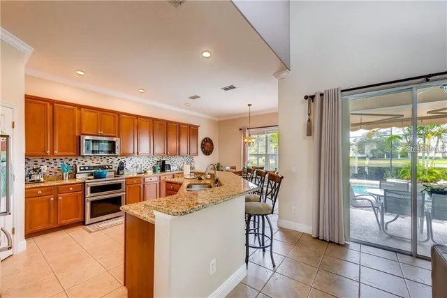 a kitchen with stainless steel appliances granite countertop a stove top oven a sink a counter top space cabinets and stainless steel appliances
