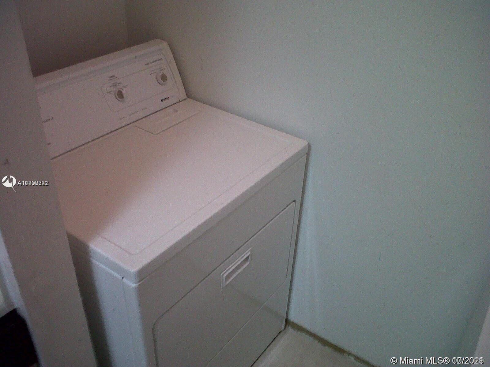 1239 Southwest 46th Avenue, Unit 906 Pompano Beach, FL 33069 - Photo 15 of 23 a utility room with dryer and washer