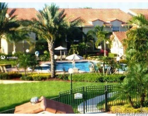 1239 Southwest 46th Avenue, Unit 906 Pompano Beach, FL 33069 - Photo 19 of 23 a view of a house with a yard