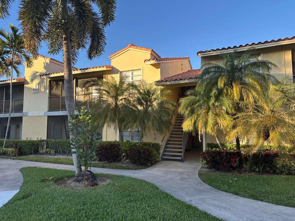 1239 Southwest 46th Avenue, Unit 906 Pompano Beach, FL 33069 - Photo 2 of 23 a view of a house with a yard