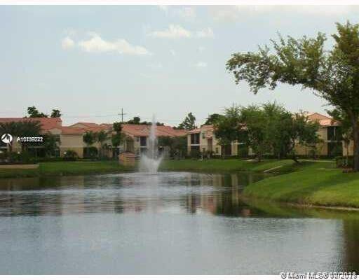 1239 Southwest 46th Avenue, Unit 906 Pompano Beach, FL 33069 - Photo 21 of 23 a view of a lake view with houses in back