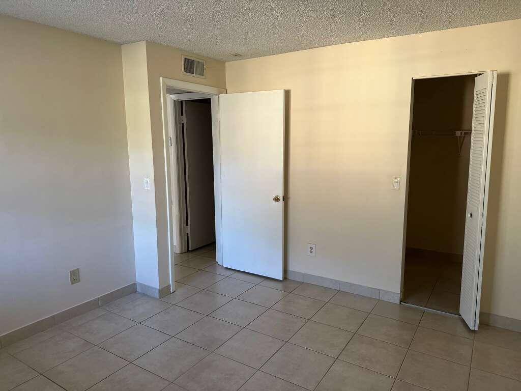 1239 Southwest 46th Avenue, Unit 906 Pompano Beach, FL 33069 - Photo 5 of 23 an empty room with closet