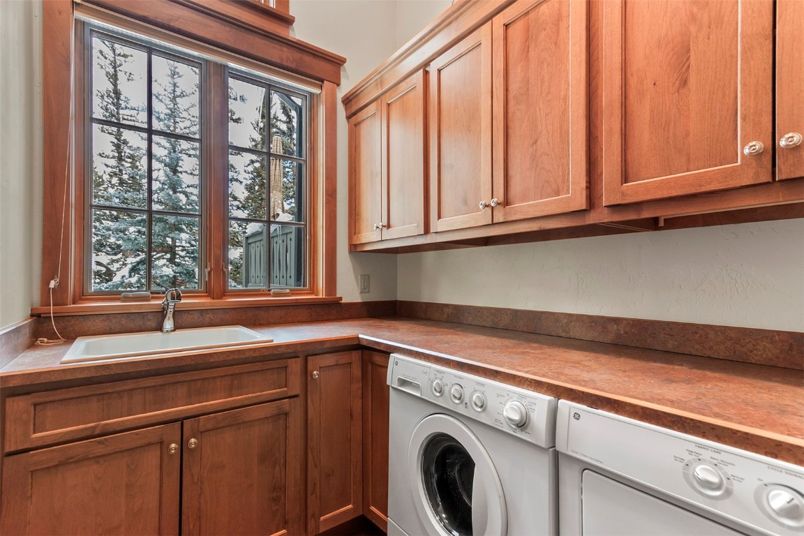 780 Penstemon Road Keystone, CO 80435 - Photo 28 of 40 a view with granite countertop cabinets washer and dryer