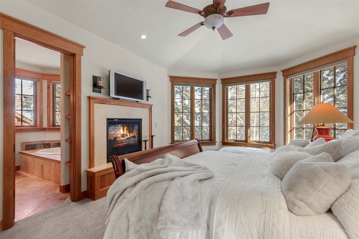 780 Penstemon Road Keystone, CO 80435 - Photo 9 of 40 a bedroom with a bed and a fireplace