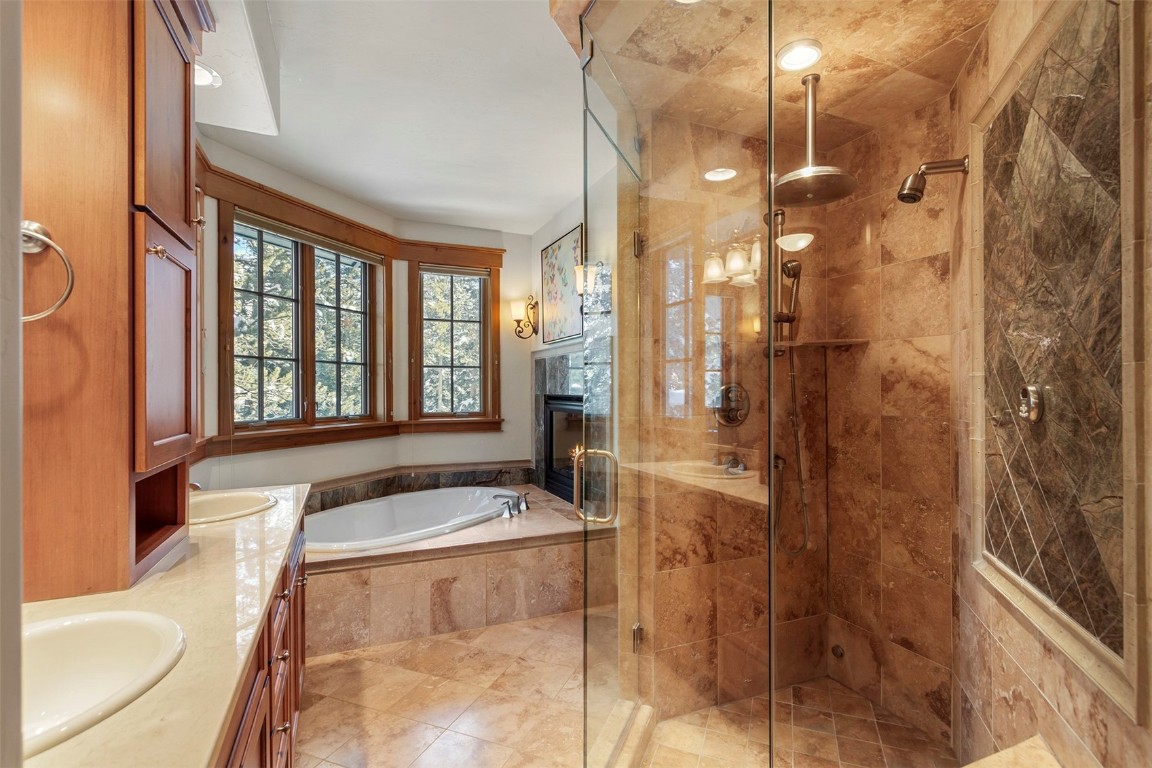 780 Penstemon Road Keystone, CO 80435 - Photo 10 of 40 a bathroom with a tub a sink and a large mirror