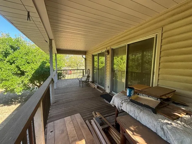a view of a balcony with floor to ceiling windows with wooden floor
