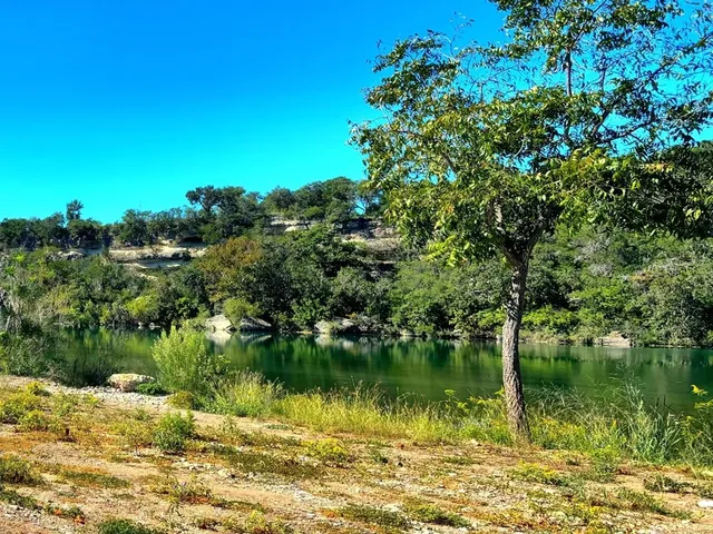 a view of lake with green space