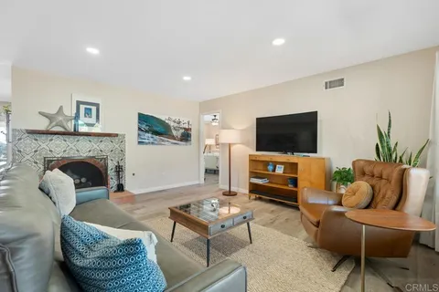 a dining room with furniture and a kitchen view