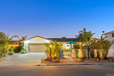 a kitchen with a dining table chairs refrigerator and cabinets