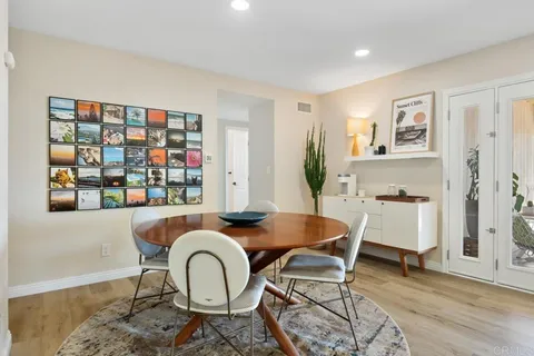 a dining room with furniture and wooden floor