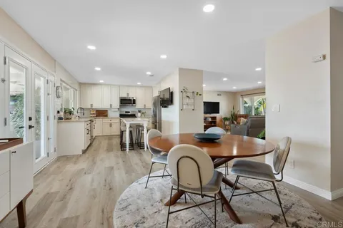 a bathroom with a sink a mirror and a potted plant