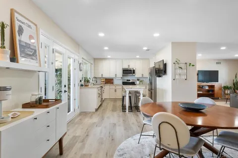 a kitchen with stainless steel appliances a stove a sink cabinets and a refrigerator