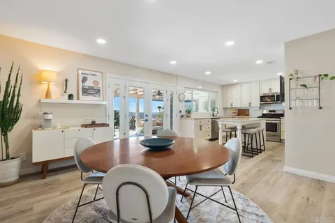 a kitchen with granite countertop a sink and white cabinets