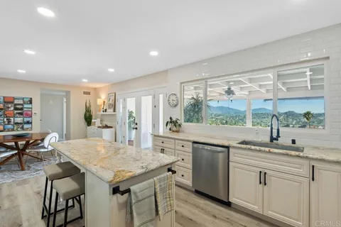 a backyard of a house with wooden floor and outdoor seating