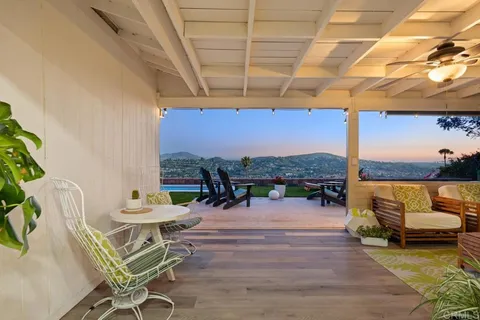 a bedroom with a bed and a large mirror