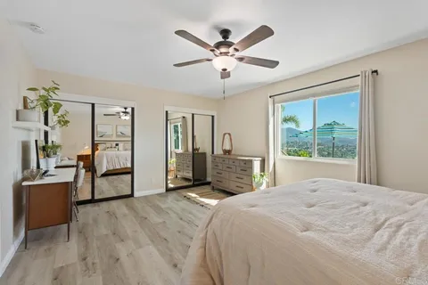 a view of a patio with a table and chairs under an umbrella
