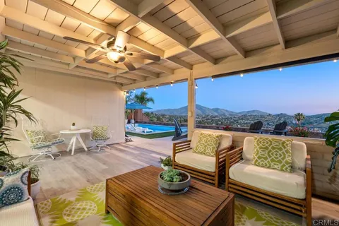 a view of a house with swimming pool and sitting area