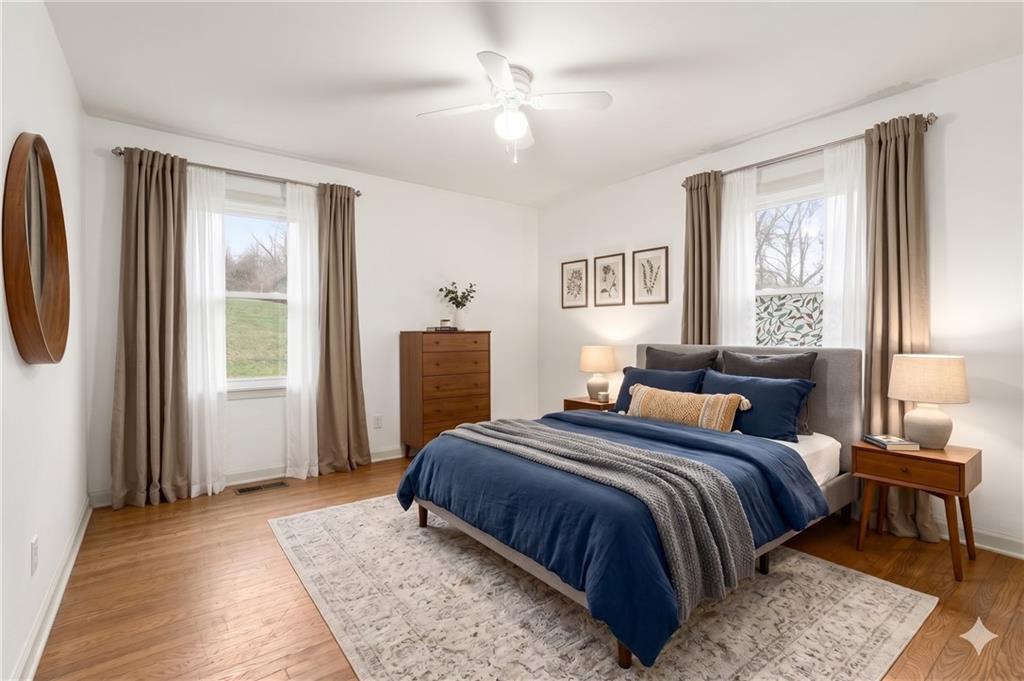 123 Wampum Road Wampum, PA 16157 - Photo 13 of 33 a bedroom with a large bed a chandelier and a window