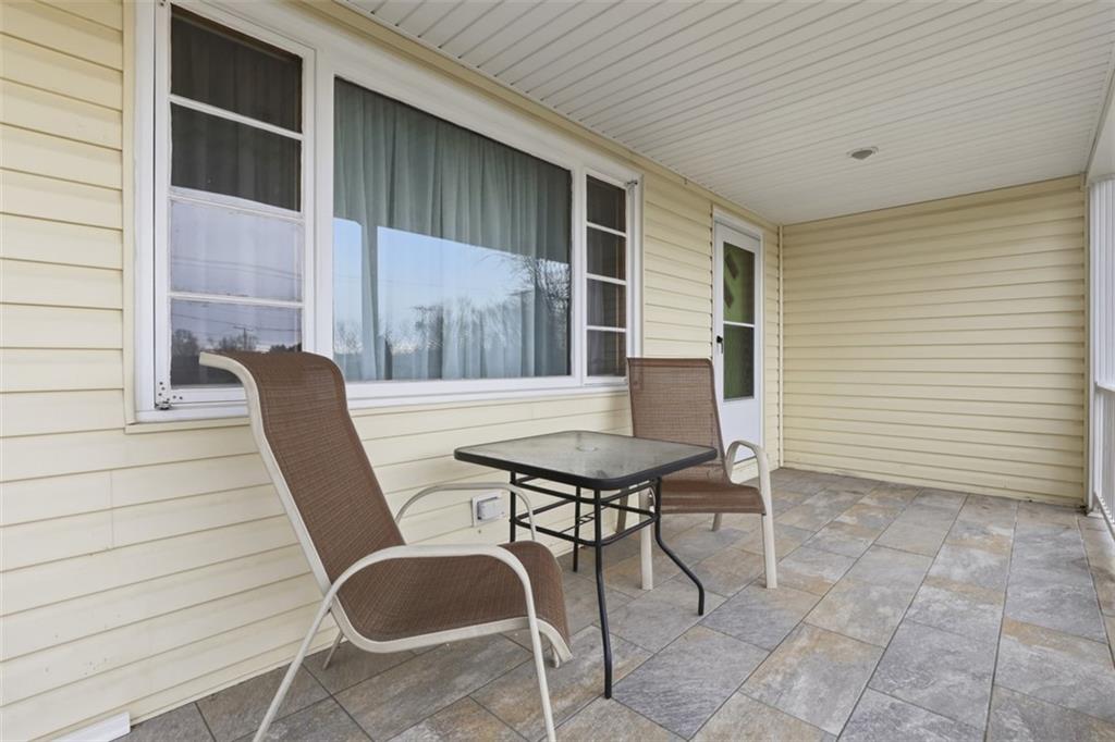 123 Wampum Road Wampum, PA 16157 - Photo 27 of 33 a balcony with table and chairs