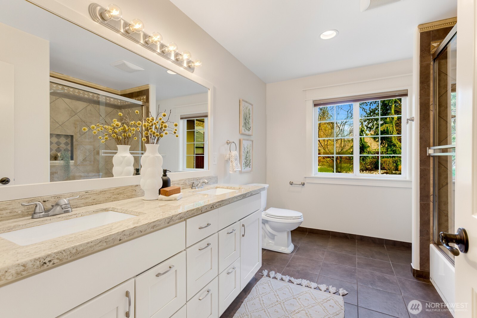 4826 196th Street Southeast Bothell, WA 98012 - Photo 14 of 40 a bathroom with a granite countertop double vanity sink a toilet and a window