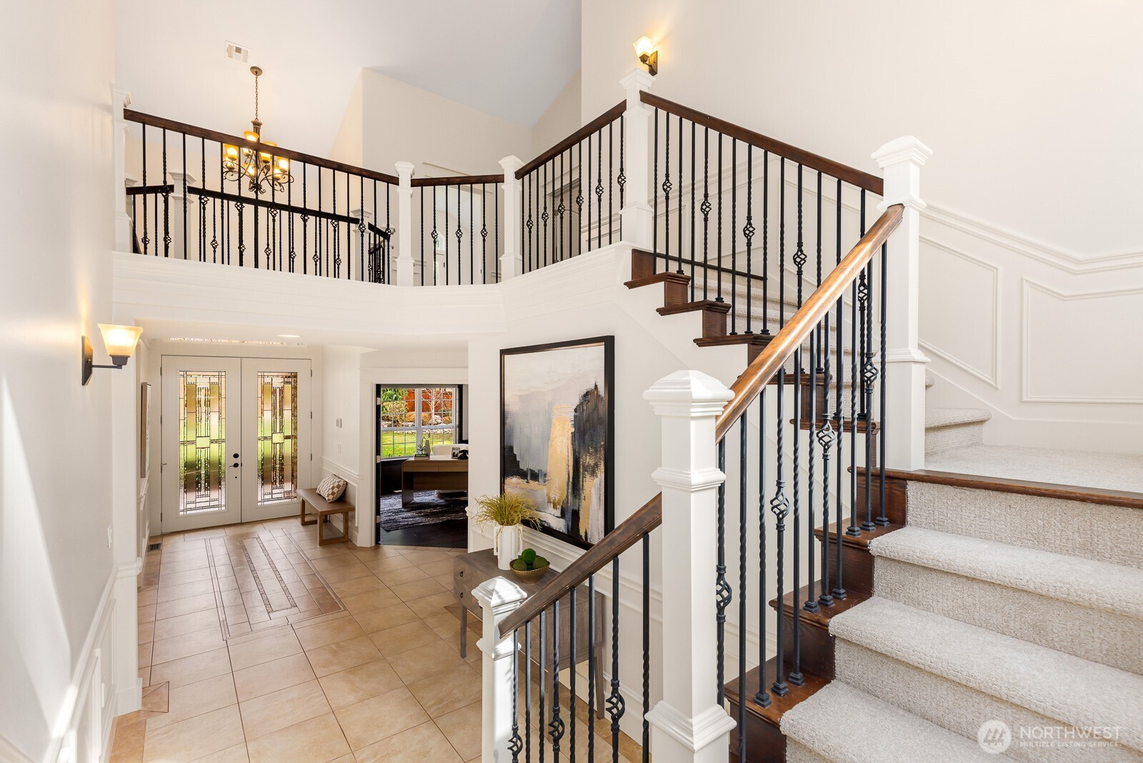 4826 196th Street Southeast Bothell, WA 98012 - Photo 19 of 40 a view of staircase with lots of frames on wall and a chandelier
