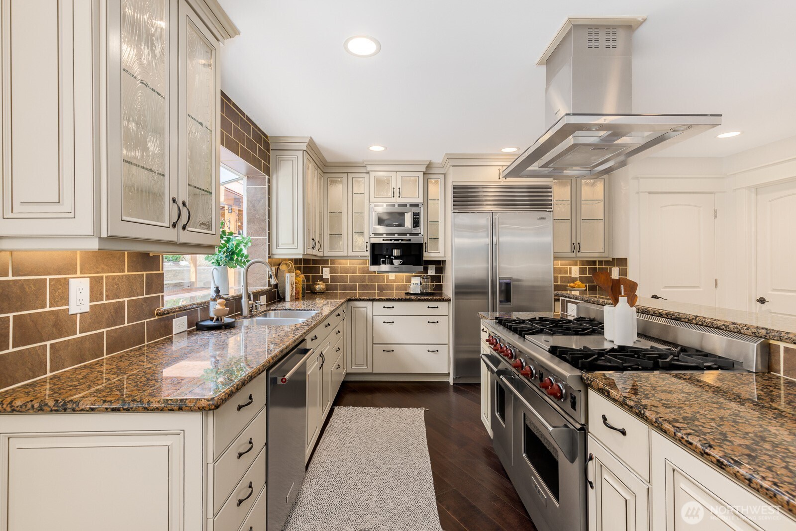 4826 196th Street Southeast Bothell, WA 98012 - Photo 10 of 40 a kitchen with granite countertop a sink stainless steel appliances and counter space