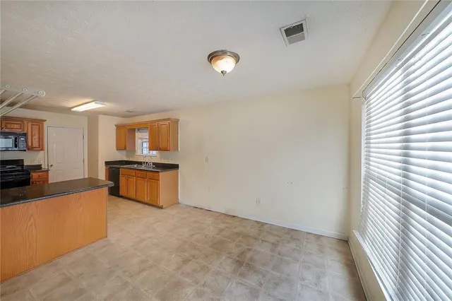a kitchen with stainless steel appliances a refrigerator and a stove top oven