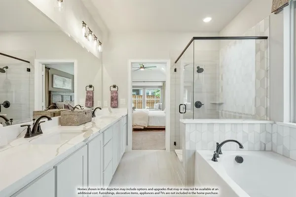 a en suite spacious bathroom with a tub sink and mirror