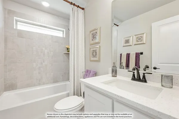 a bathroom with a granite countertop sink a toilet and shower