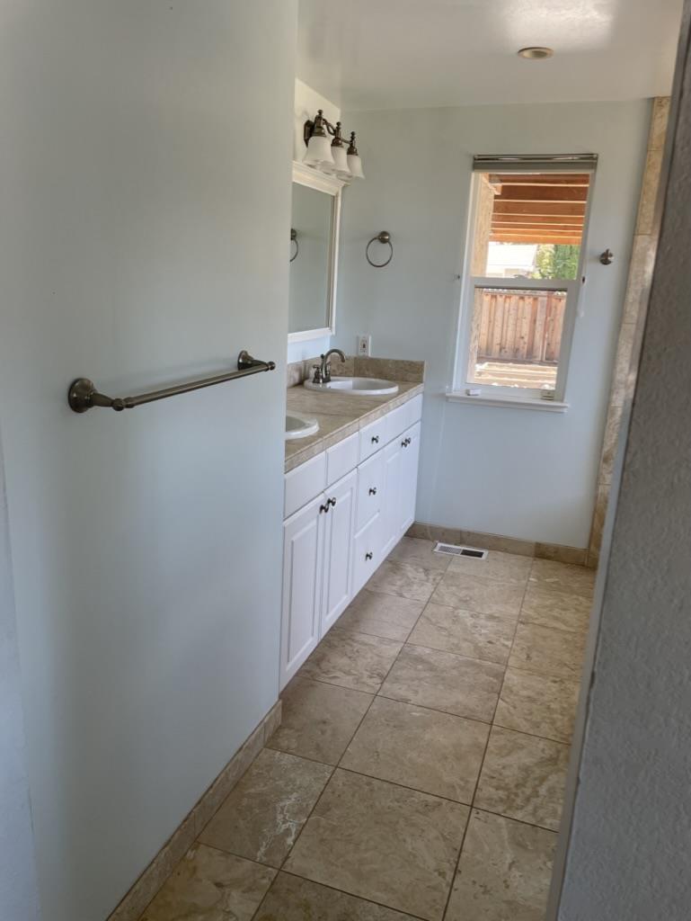 3550 Slopeview Drive San Jose, CA 95148 - Photo 5 of 7 a bathroom with a granite countertop sink a mirror and a bathtub