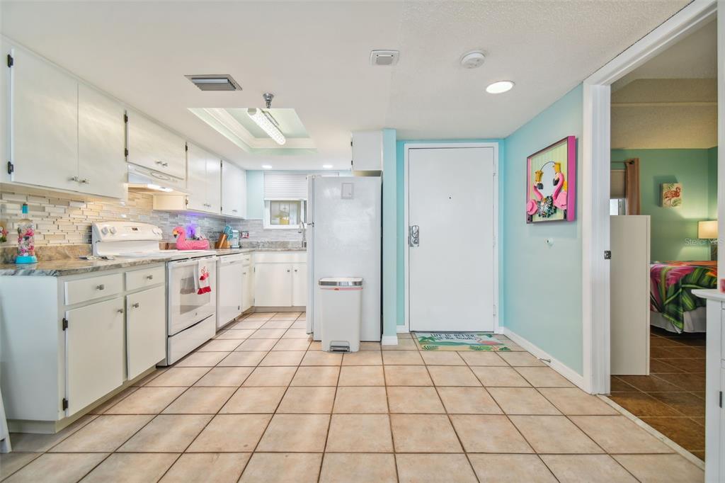 5915 Sea Ranch Drive, Unit 308 Hudson, FL 34667 - Photo 12 of 64 a kitchen with stainless steel appliances a refrigerator sink and cabinets