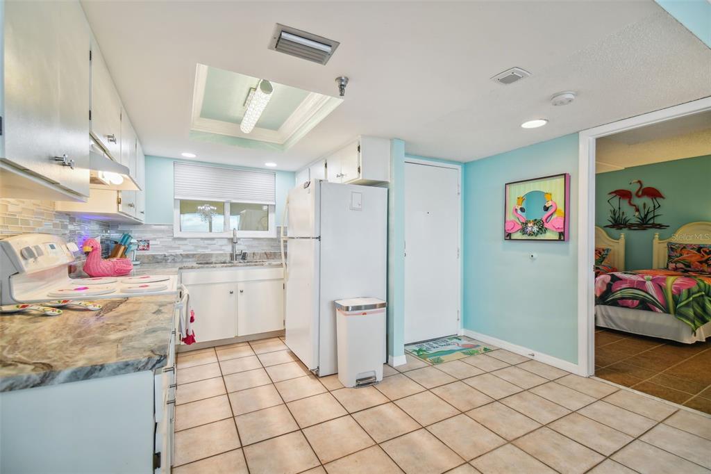 5915 Sea Ranch Drive, Unit 308 Hudson, FL 34667 - Photo 13 of 64 a kitchen with stainless steel appliances kitchen island granite countertop a refrigerator and a stove