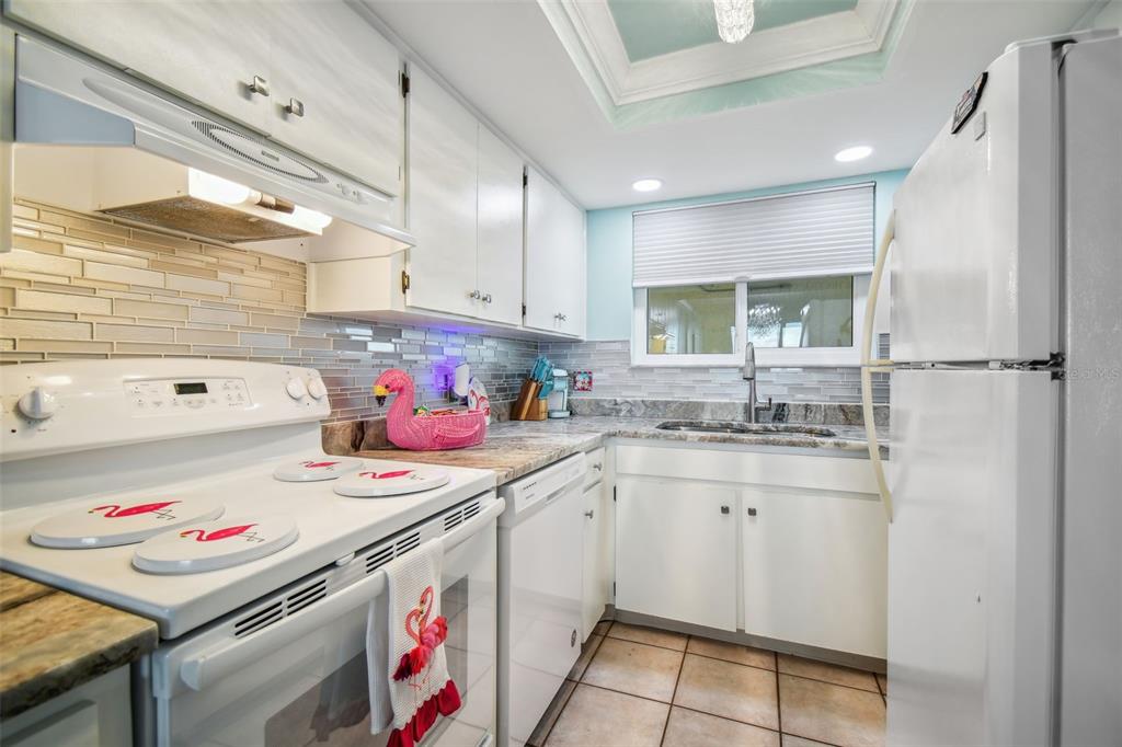 5915 Sea Ranch Drive, Unit 308 Hudson, FL 34667 - Photo 14 of 64 a kitchen with a sink a stove and cabinets
