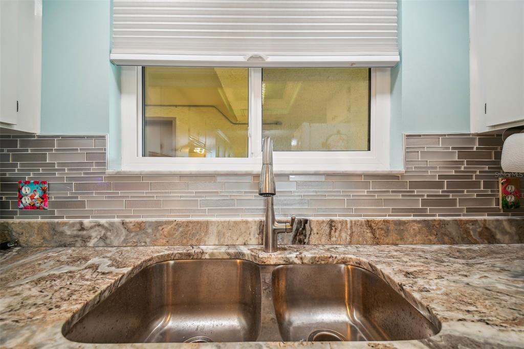 5915 Sea Ranch Drive, Unit 308 Hudson, FL 34667 - Photo 15 of 64 a kitchen with a sink and a window