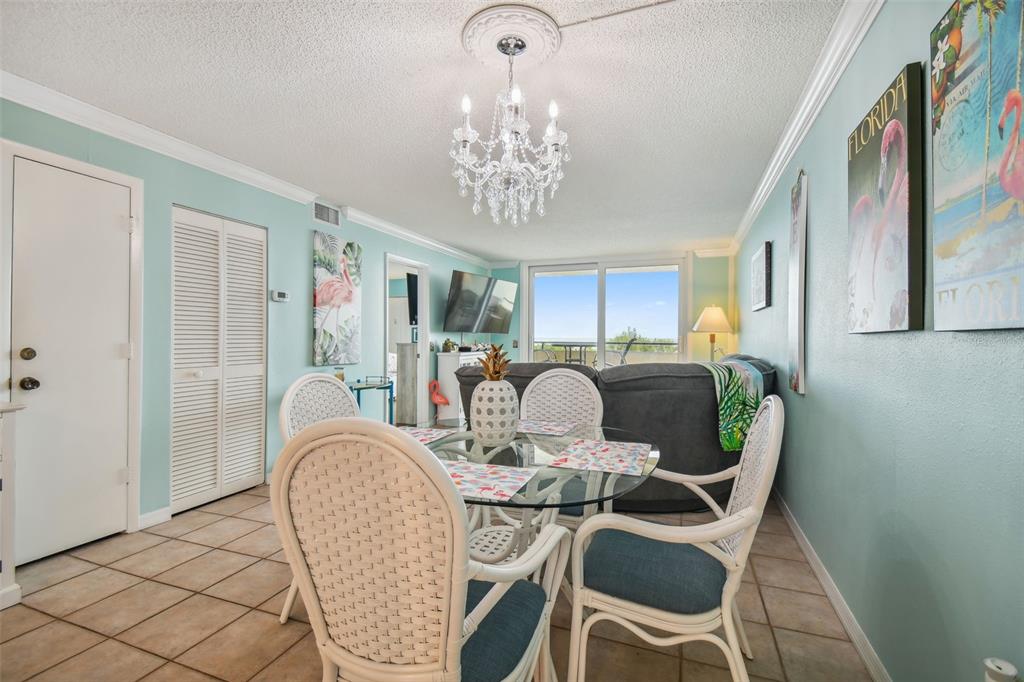 5915 Sea Ranch Drive, Unit 308 Hudson, FL 34667 - Photo 17 of 64 a dining room with furniture a chandelier and window